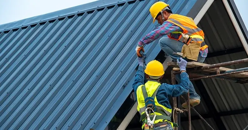 Two-roofers-work-together-to-install-metal-roof